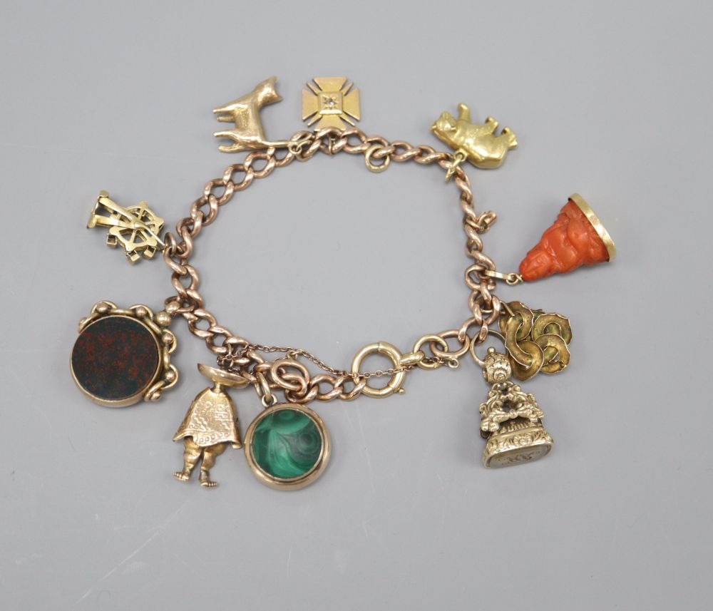 An 18ct gold curblink charm bracelet, hung with ten assorted charms, gross 58 grams